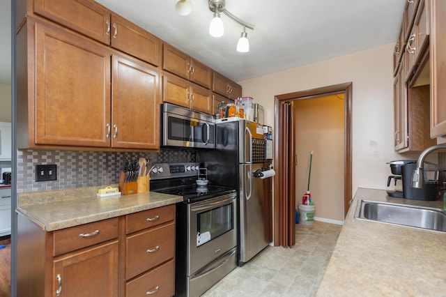 1609 Sheridan Ave, Niles, MI 49120 - kitchen with stainless steel appliances, a sink, tasteful backsplash, light countertops, and brown cabinetry