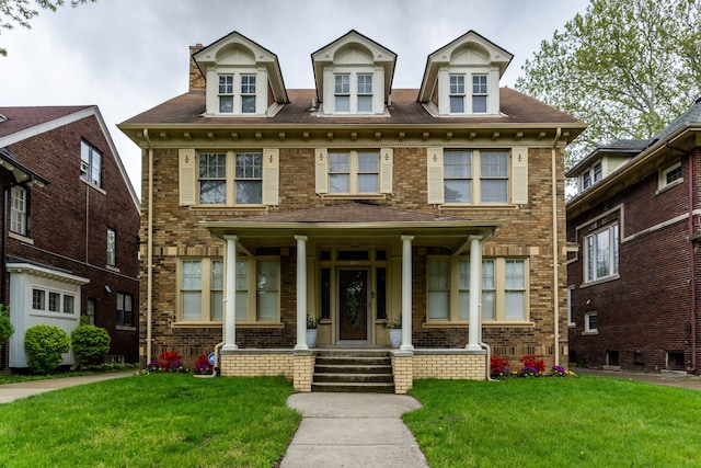 2285 Chicago Blvd, Detroit, MI 48206 - view of front of property featuring a porch, a front yard, and brick siding