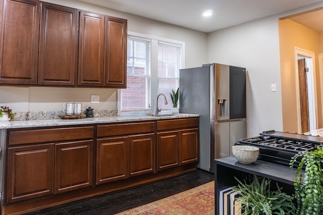 2285 Chicago Blvd, Detroit, MI 48206 - kitchen with stainless steel refrigerator with ice dispenser, a sink, light stone counters, dark wood-type flooring, and recessed lighting
