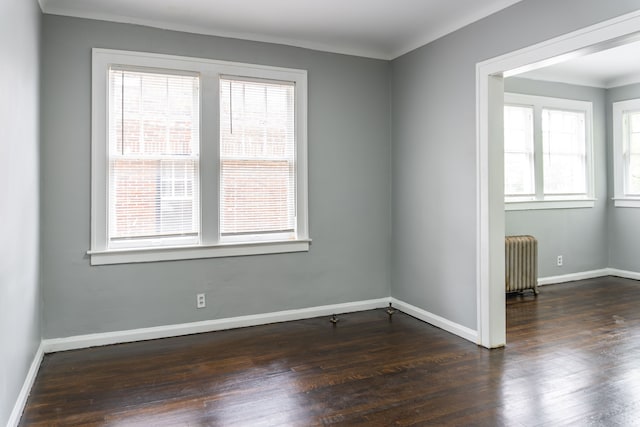 2285 Chicago Blvd, Detroit, MI 48206 - spare room with radiator heating unit, healthy amount of natural light, and dark wood-type flooring