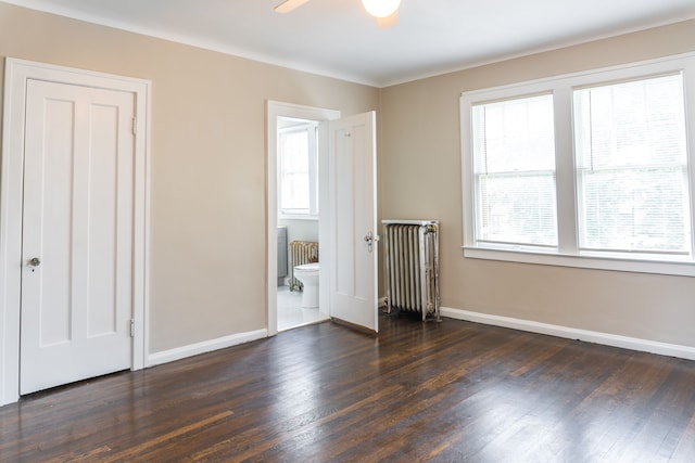 2285 Chicago Blvd, Detroit, MI 48206 - unfurnished bedroom featuring radiator heating unit, dark wood finished floors, and baseboards