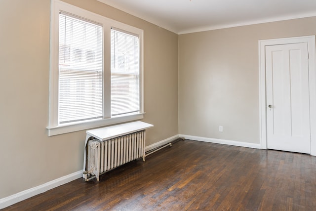 2285 Chicago Blvd, Detroit, MI 48206 - spare room featuring radiator, wood finished floors, and baseboards