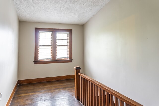 2285 Chicago Blvd, Detroit, MI 48206 - empty room featuring wood finished floors, a textured ceiling, and baseboards