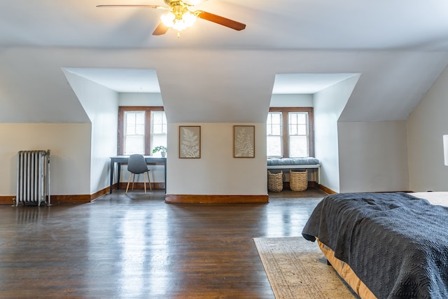 2285 Chicago Blvd, Detroit, MI 48206 - bedroom with radiator heating unit, lofted ceiling, multiple windows, dark wood-style floors, and baseboards
