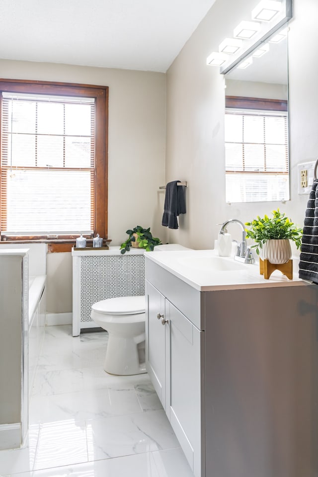2285 Chicago Blvd, Detroit, MI 48206 - full bath with toilet, marble finish floors, vanity, a bathtub, and baseboards