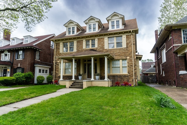 2285 Chicago Blvd, Detroit, MI 48206 - view of front of property with covered porch, a front yard, and brick siding
