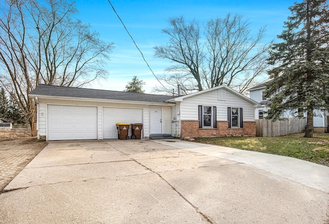 238-240 W Division St, Sparta, MI 49345 - view of front of house with brick siding, concrete driveway, fence, and an attached garage