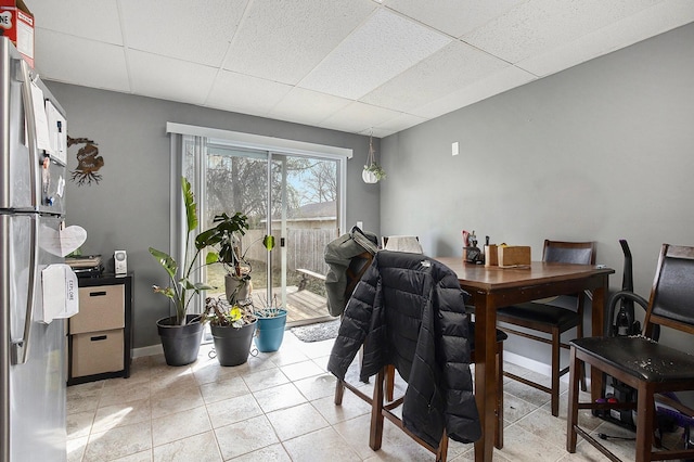 238-240 W Division St, Sparta, MI 49345 - dining space featuring a drop ceiling, light tile patterned flooring, and baseboards