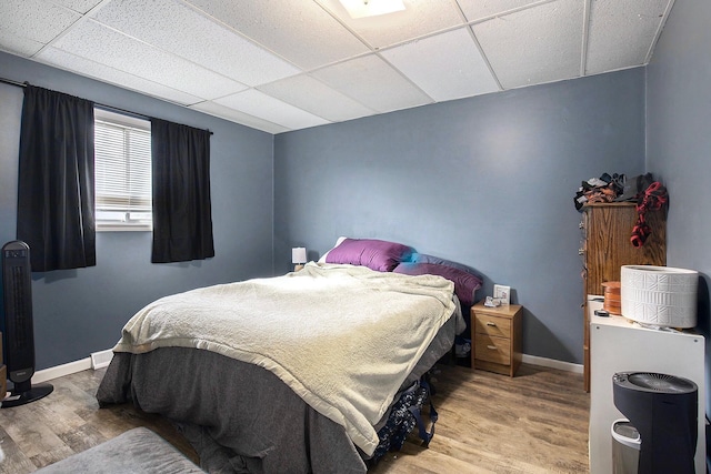 238-240 W Division St, Sparta, MI 49345 - bedroom featuring a paneled ceiling, wood finished floors, and baseboards