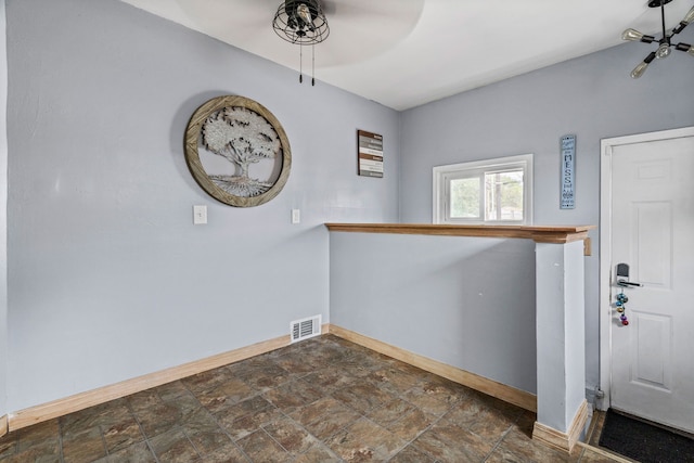 30664 Burlington St, Westland, MI 48186 - foyer entrance featuring ceiling fan, baseboards, and stone finish floors