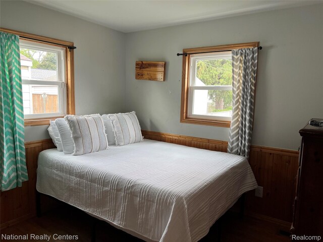 30664 Burlington St, Westland, MI 48186 - bedroom featuring multiple windows, wood walls, and wainscoting