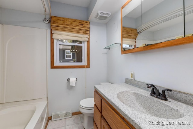 1169 Sluyter St SE, Grand Rapids, MI 49508 - bathroom featuring toilet, a bath, tile patterned flooring, vanity, and baseboards