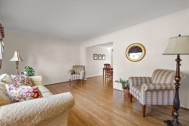 living room featuring ornamental molding and wood finished floors