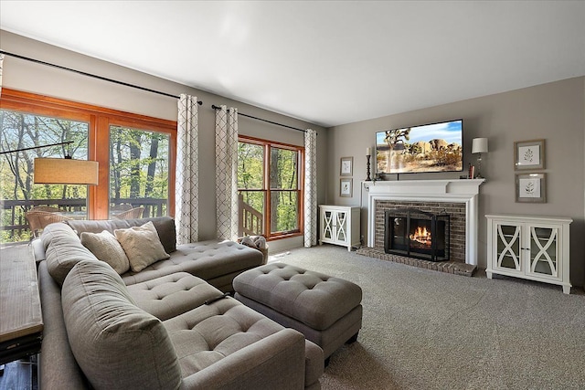 living area with carpet and a fireplace