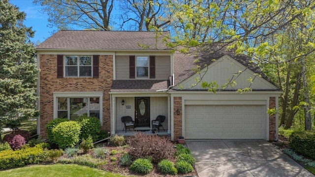 traditional-style home featuring brick siding, driveway, an attached garage, and roof with shingles