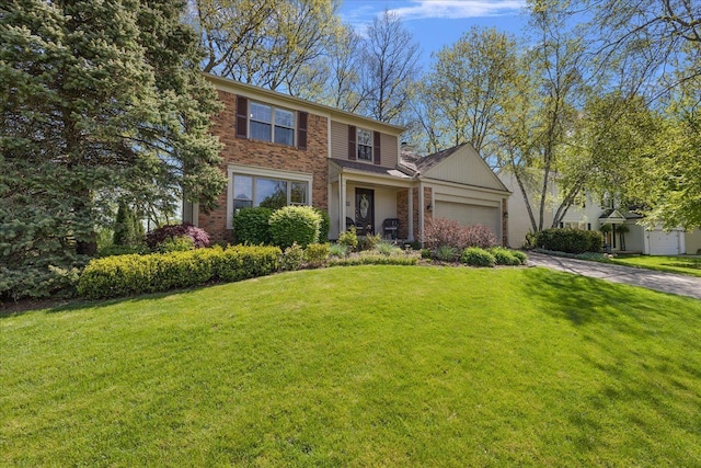 traditional-style house with brick siding, driveway, a front yard, and a garage