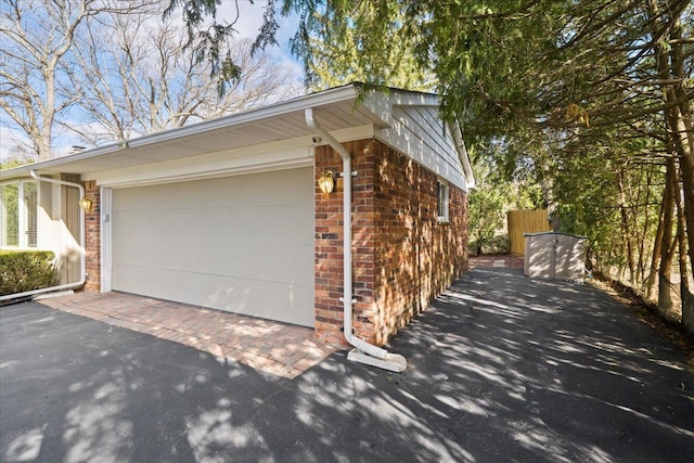5080 Kitson Ln, West Bloomfield, MI 48324 - view of property exterior featuring brick siding, driveway, and a garage