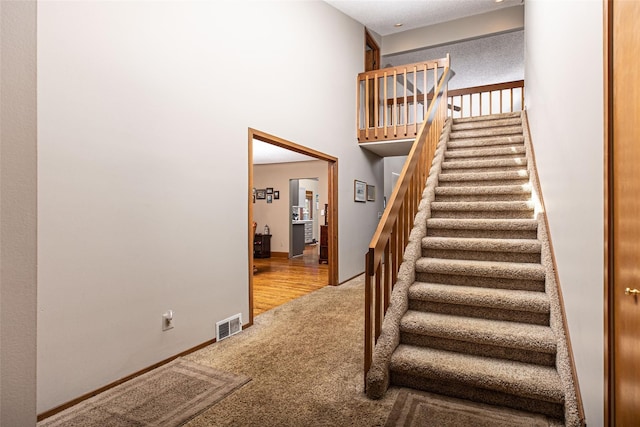 3541 Highland Blvd, Highland, MI 48356 - stairs with carpet and a towering ceiling