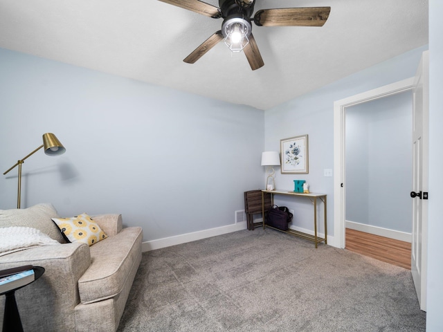 119 Maple St, Fife Lake, MI 49633 - living area with a ceiling fan, carpet, and baseboards