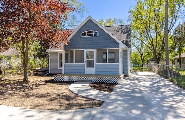 8345 Pontiac Lake Rd, White Lake, MI 48386 - bungalow-style house featuring fence and roof with shingles