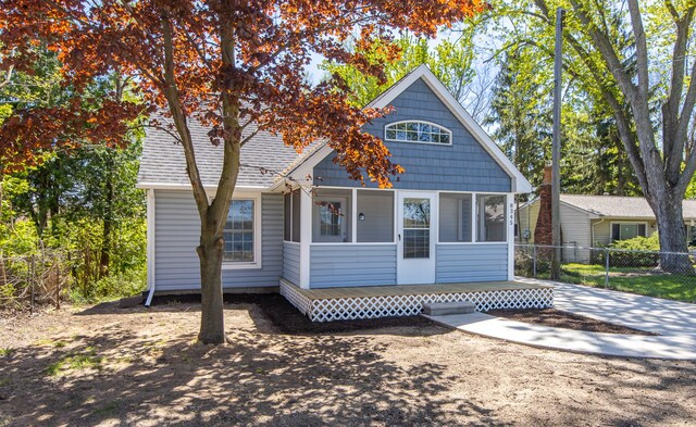 8345 Pontiac Lake Rd, White Lake, MI 48386 - view of front of house with fence and a sunroom