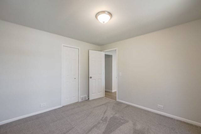 8345 Pontiac Lake Rd, White Lake, MI 48386 - unfurnished bedroom featuring carpet floors, baseboards, and a closet