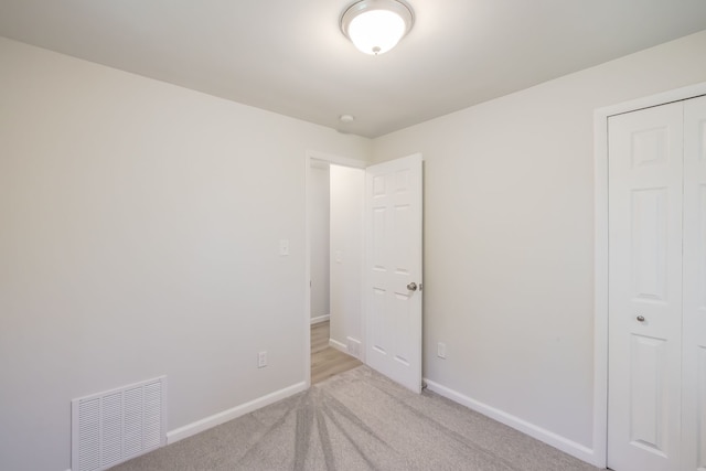 8345 Pontiac Lake Rd, White Lake, MI 48386 - unfurnished bedroom with carpet, baseboards, and a closet