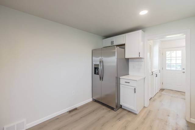 8345 Pontiac Lake Rd, White Lake, MI 48386 - kitchen with stainless steel fridge with ice dispenser, light wood-style flooring, white cabinetry, light countertops, and recessed lighting