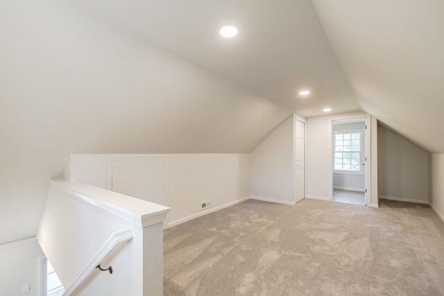 8345 Pontiac Lake Rd, White Lake, MI 48386 - additional living space with light colored carpet, lofted ceiling, baseboards, and recessed lighting