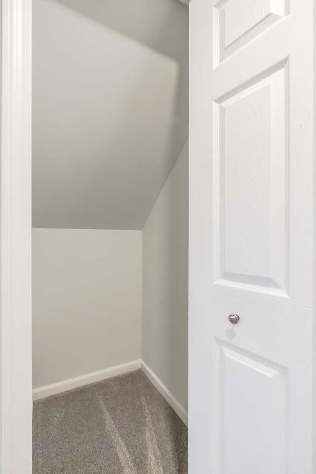 8345 Pontiac Lake Rd, White Lake, MI 48386 - additional living space featuring vaulted ceiling, carpet floors, and baseboards