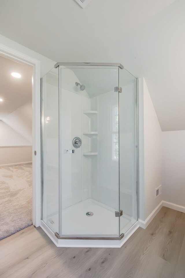 8345 Pontiac Lake Rd, White Lake, MI 48386 - full bath with wood finished floors, a shower stall, baseboards, and vaulted ceiling