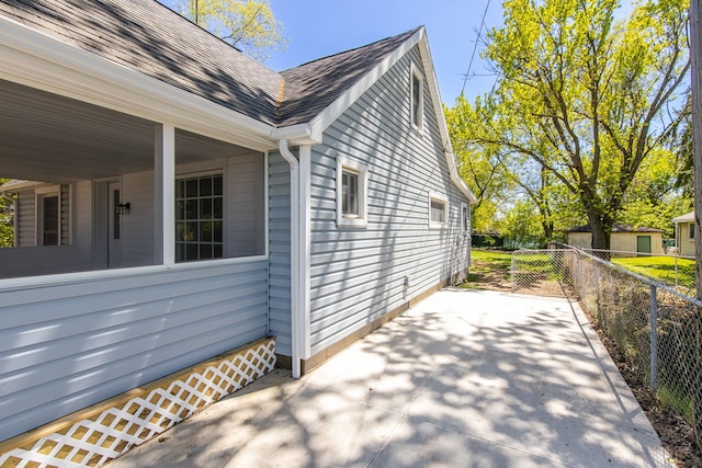 8345 Pontiac Lake Rd, White Lake, MI 48386 - view of side of home featuring fence and a shingled roof