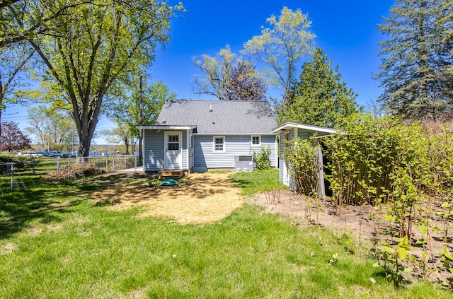 8345 Pontiac Lake Rd, White Lake, MI 48386 - rear view of house featuring central AC, an outdoor structure, roof with shingles, and a storage unit