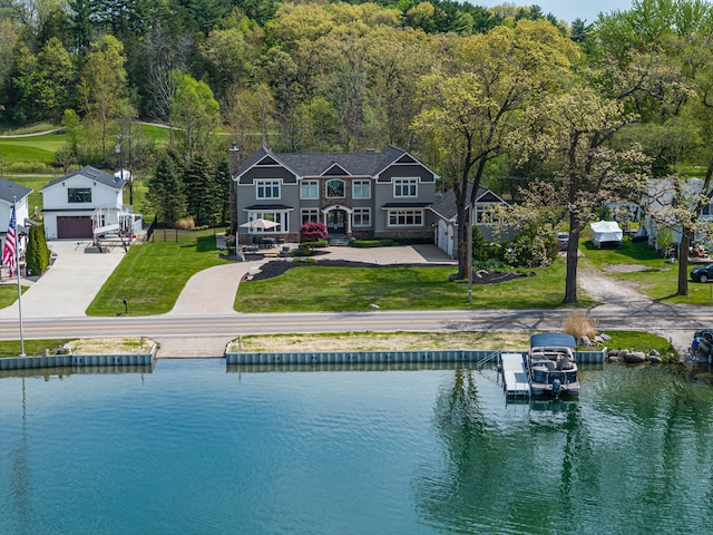 back of property featuring a water view, a yard, and a chimney