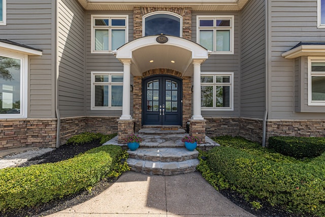 view of exterior entry with french doors and stone siding