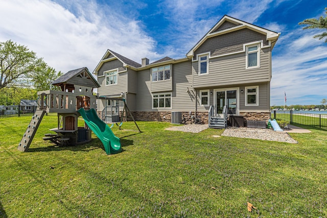back of property featuring a playground, stone siding, central air condition unit, and entry steps
