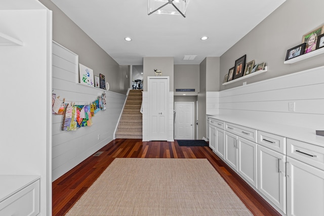 interior space with dark wood-type flooring, recessed lighting, and stairway