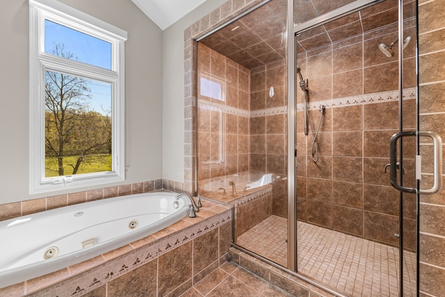 bathroom featuring a tub with jets and a stall shower
