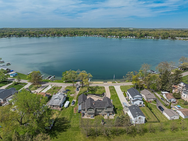 aerial overview of property's location featuring nearby suburban area and a nearby body of water