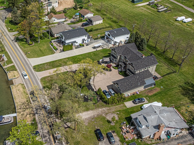 aerial view of property and surrounding area featuring nearby suburban area