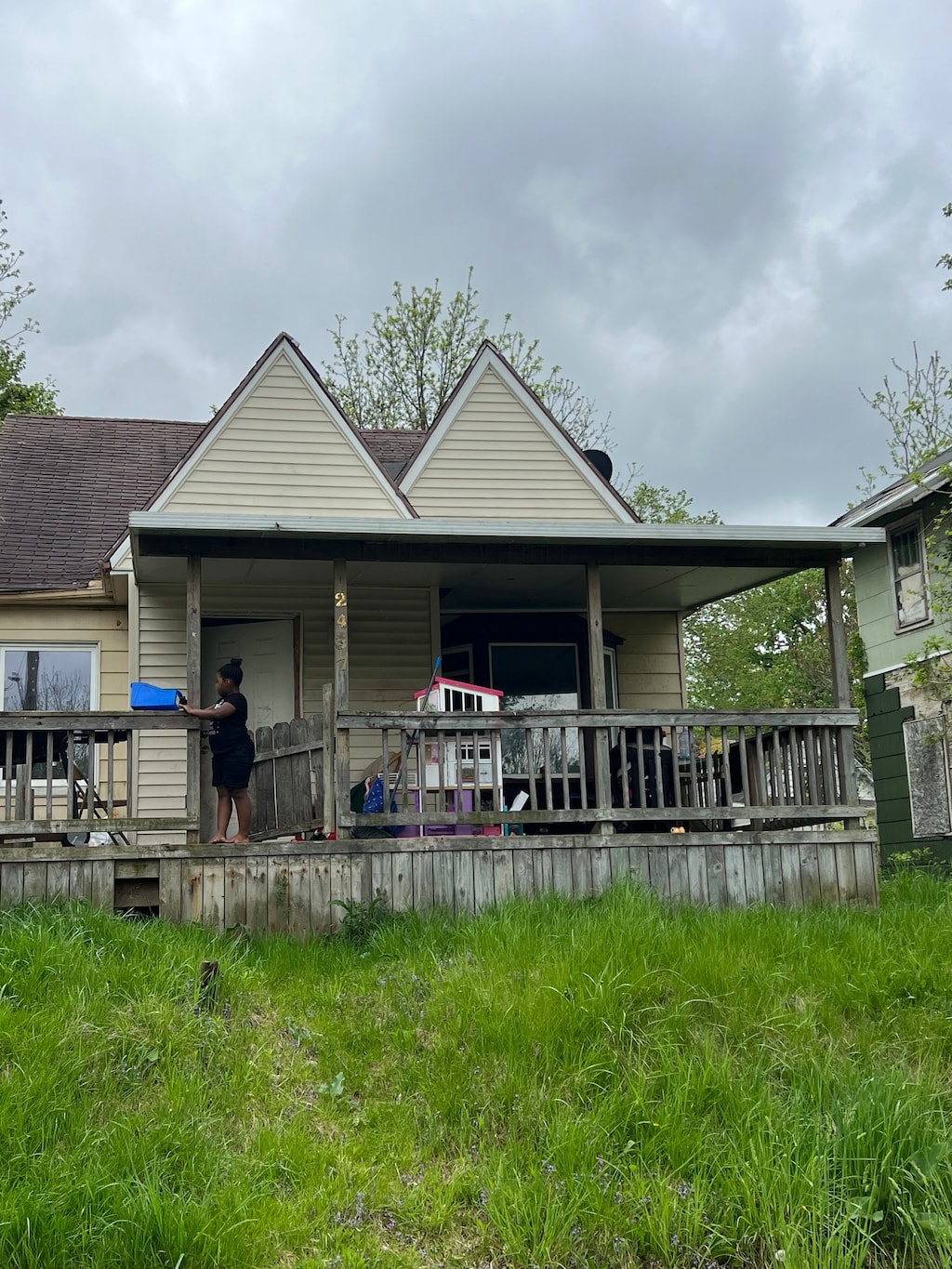 2437 Zimmerman St, Flint, MI 48503 - view of front of house with covered porch and an attached garage