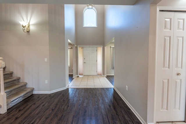 52201 Boland Rd, Chesterfield, MI 48047 - foyer entrance featuring wood finished floors, baseboards, a high ceiling, and stairs