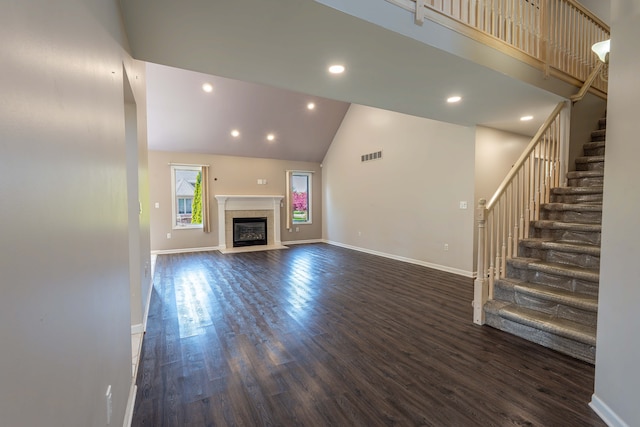 52201 Boland Rd, Chesterfield, MI 48047 - unfurnished living room featuring high vaulted ceiling, dark wood-style flooring, stairs, baseboards, and recessed lighting
