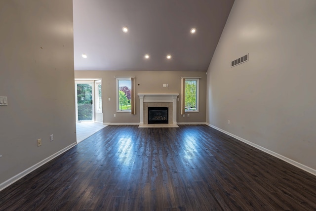 52201 Boland Rd, Chesterfield, MI 48047 - unfurnished living room with baseboards, high vaulted ceiling, recessed lighting, dark wood-type flooring, and a tiled fireplace