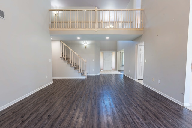 52201 Boland Rd, Chesterfield, MI 48047 - unfurnished living room featuring a high ceiling, baseboards, stairway, and wood finished floors