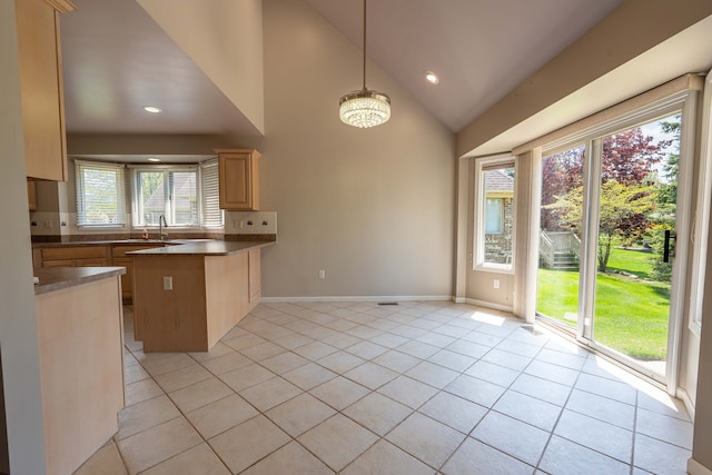 52201 Boland Rd, Chesterfield, MI 48047 - kitchen featuring a peninsula, light tile patterned floors, light brown cabinets, baseboards, and dark countertops