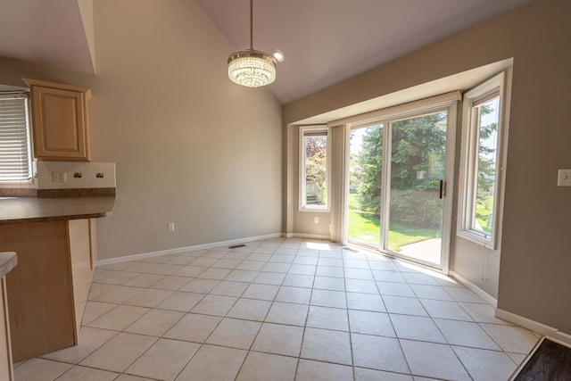 52201 Boland Rd, Chesterfield, MI 48047 - unfurnished dining area featuring a chandelier, light tile patterned floors, baseboards, and high vaulted ceiling