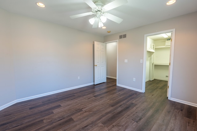 52201 Boland Rd, Chesterfield, MI 48047 - unfurnished bedroom with dark wood-style floors, baseboards, a spacious closet, recessed lighting, and a ceiling fan