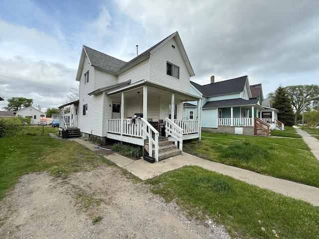 1917 16th St, Port Huron, MI 48060 - view of front of house with covered porch and a front yard