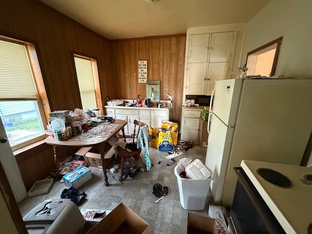 1917 16th St, Port Huron, MI 48060 - kitchen with wood walls, white range with electric stovetop, and wood finished floors